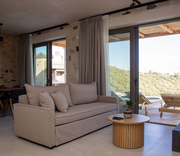 Comfortable Living room next to the balcony door leading to the pool area