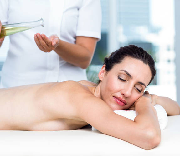Woman enjoying a relaxing massage with essential oils at the spa